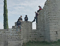 des jeunes sont assis en hauteur sur les ruines d'une ancienne cathédrale - Agrandir l'image (fenêtre modale)